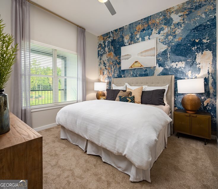 1399 Herrington Road, Unit 1202 Lawrenceville, GA 30044 - Photo 10 of 32 a bed sitting in a bedroom next to a window