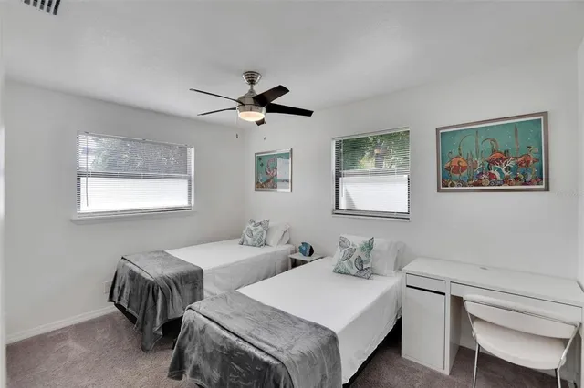 a bedroom with a bed and a painting on the wall