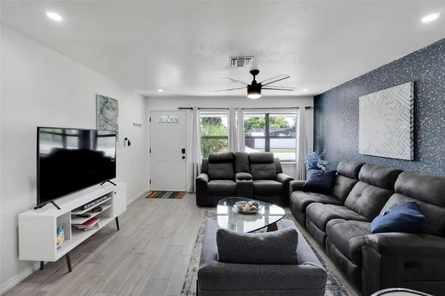 a living room with furniture and a flat screen tv