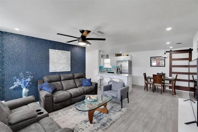 a kitchen with stainless steel appliances granite countertop a sink and a refrigerator