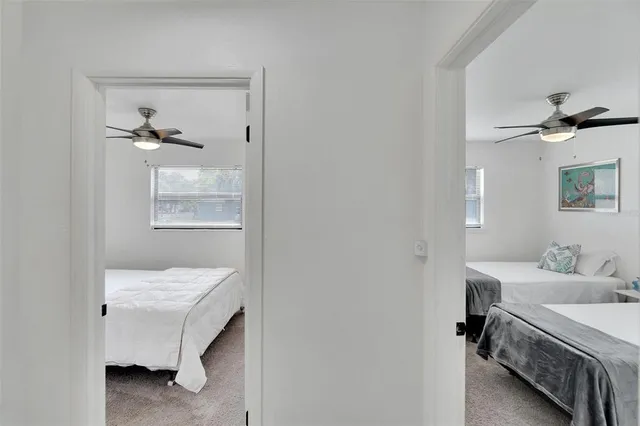 a bedroom with a bed and painting on the wall