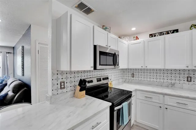 a view of a living room with furniture and a wooden floor