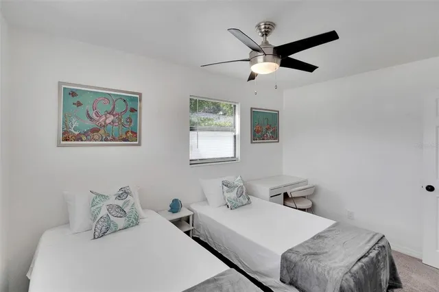 a bedroom with a bed and a painting on the wall