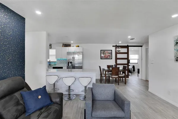 a living room with furniture and a dining room with furniture