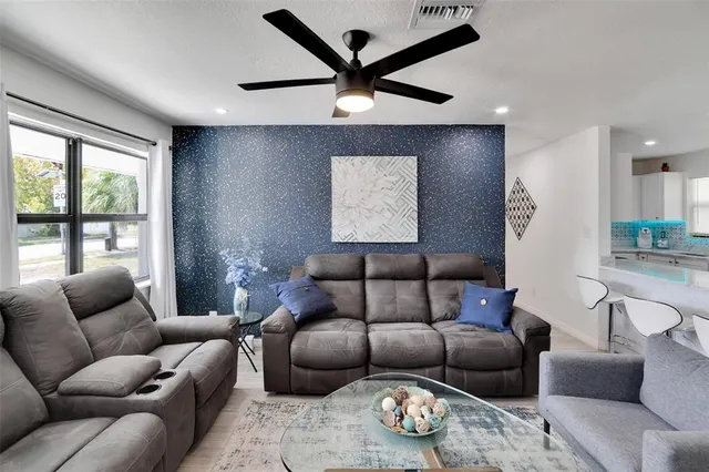 a living room with furniture a rug and a large window