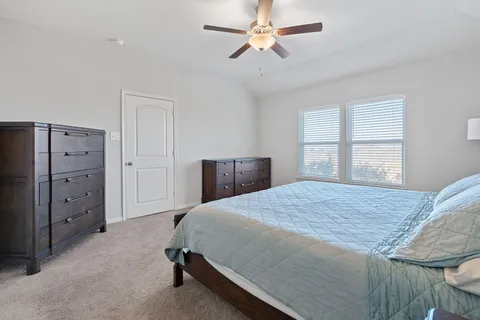 a bedroom with a bed and a dresser