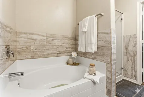 a bathroom with a tub and shower
