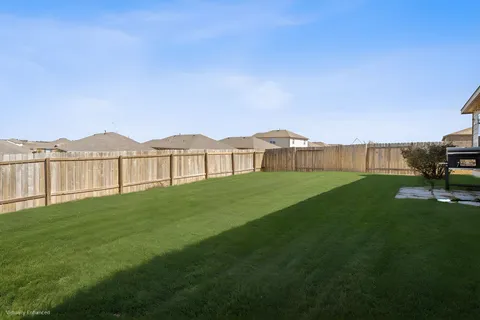 a view of an house with backyard and porch