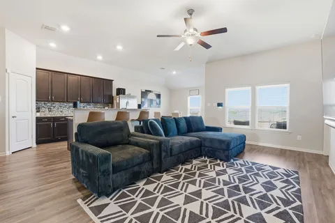a living room with furniture and kitchen view