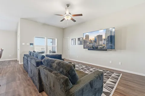 a living room with furniture and a wooden floor