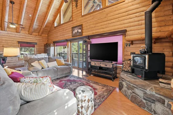 a dining room with wooden floor and stairs