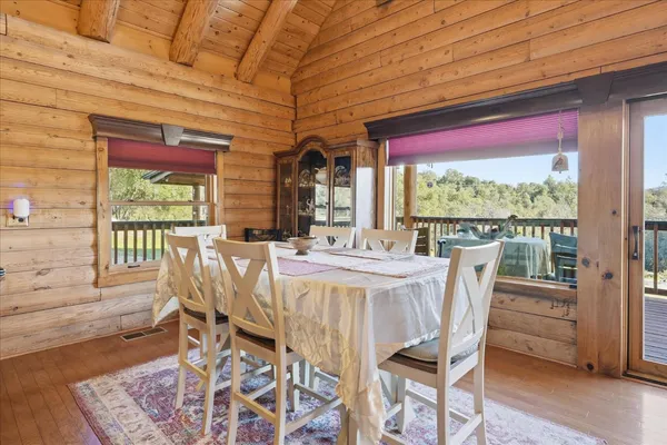 a kitchen with stainless steel appliances granite countertop a refrigerator a stove and a sink with wooden cabinets