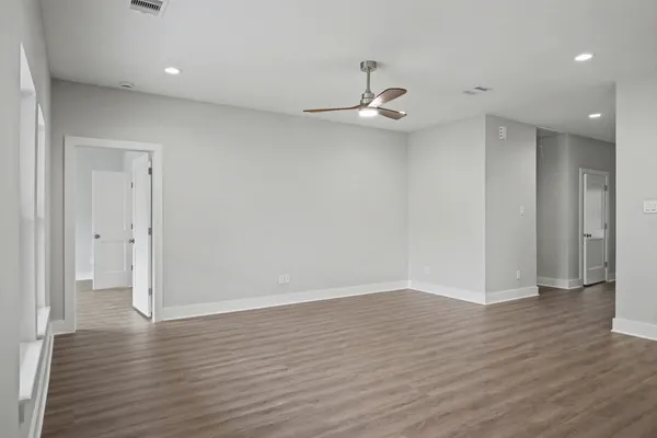 a view of an empty room with wooden floor