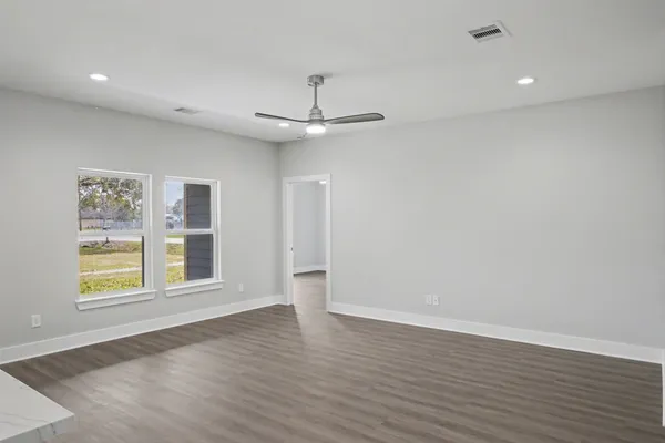 wooden floor in an empty room with a window