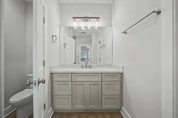 a bathroom with a granite countertop sink toilet and shower