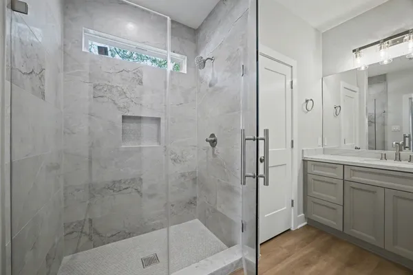 a bathroom with a shower and a sink