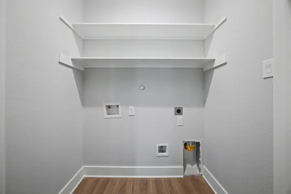 a view of walk in closet with clothes