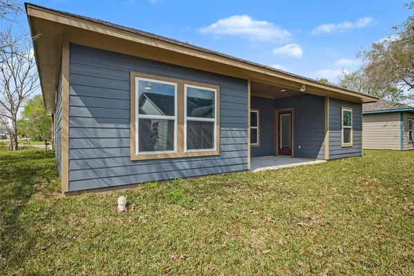 a view of house with backyard space and garden
