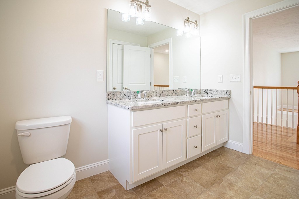 68 Little Turnpike Road Shirley, MA 01464 - Photo 27 of 40 a bathroom with a granite countertop toilet sink and mirror