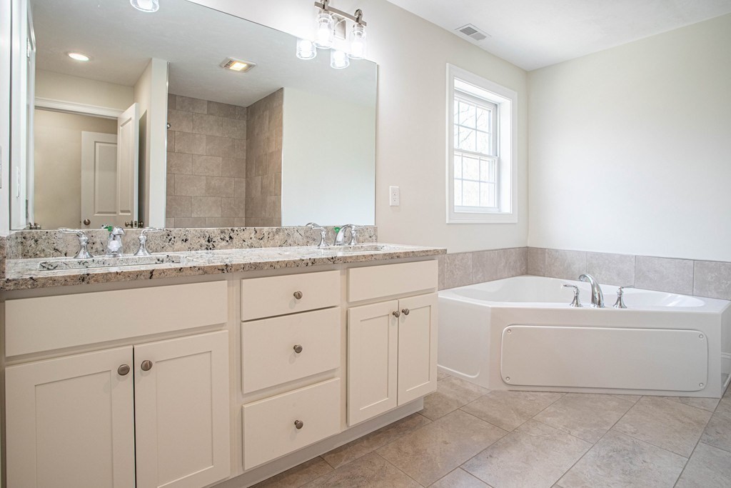 68 Little Turnpike Road Shirley, MA 01464 - Photo 32 of 40 a spacious bathroom with a double vanity sink mirror and bathtub