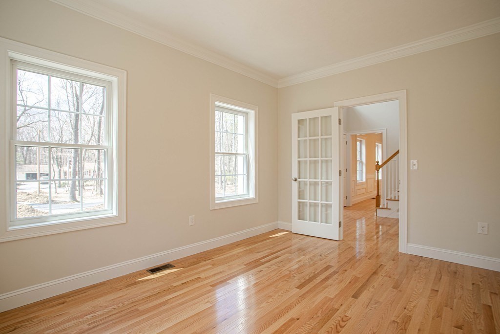 68 Little Turnpike Road Shirley, MA 01464 - Photo 8 of 40 an empty room with wooden floor and windows