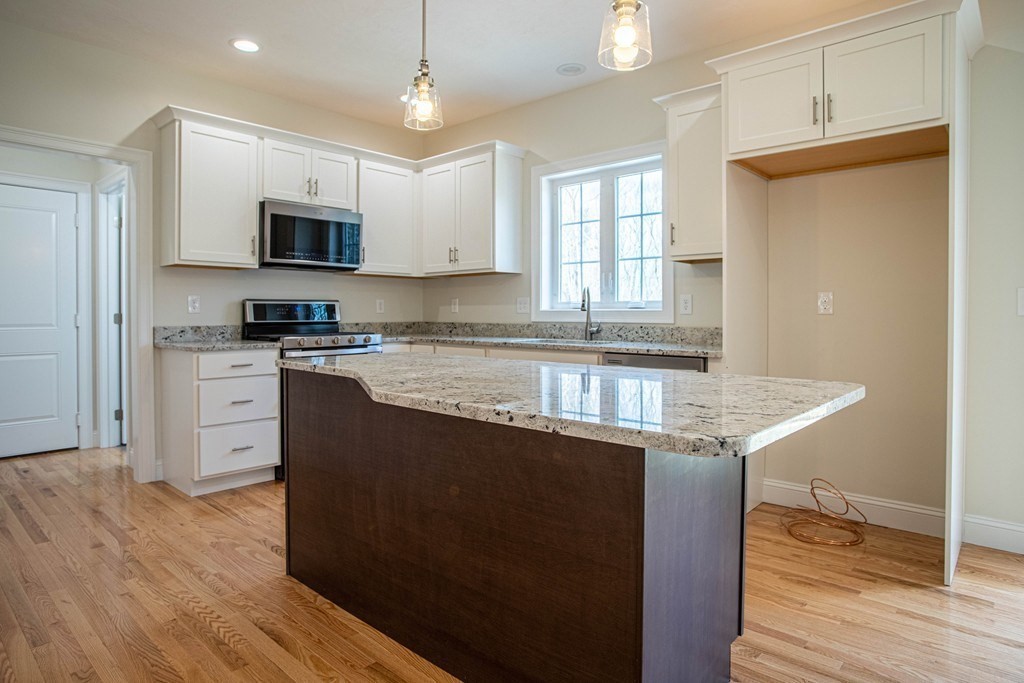 68 Little Turnpike Road Shirley, MA 01464 - Photo 9 of 40 a kitchen with stainless steel appliances granite countertop a stove a sink and a refrigerator