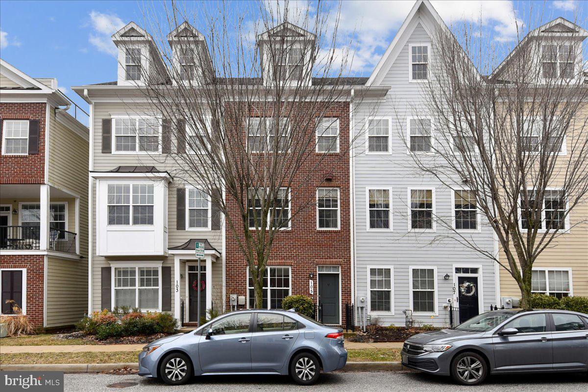 a front view of a residential apartment building with parking space