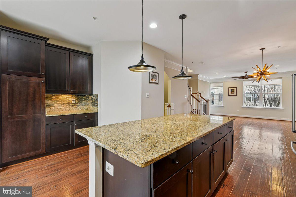 105 Meridian Lane Towson, MD 21286 - Photo 13 of 56 a kitchen with kitchen island granite countertop wooden cabinets and refrigerator