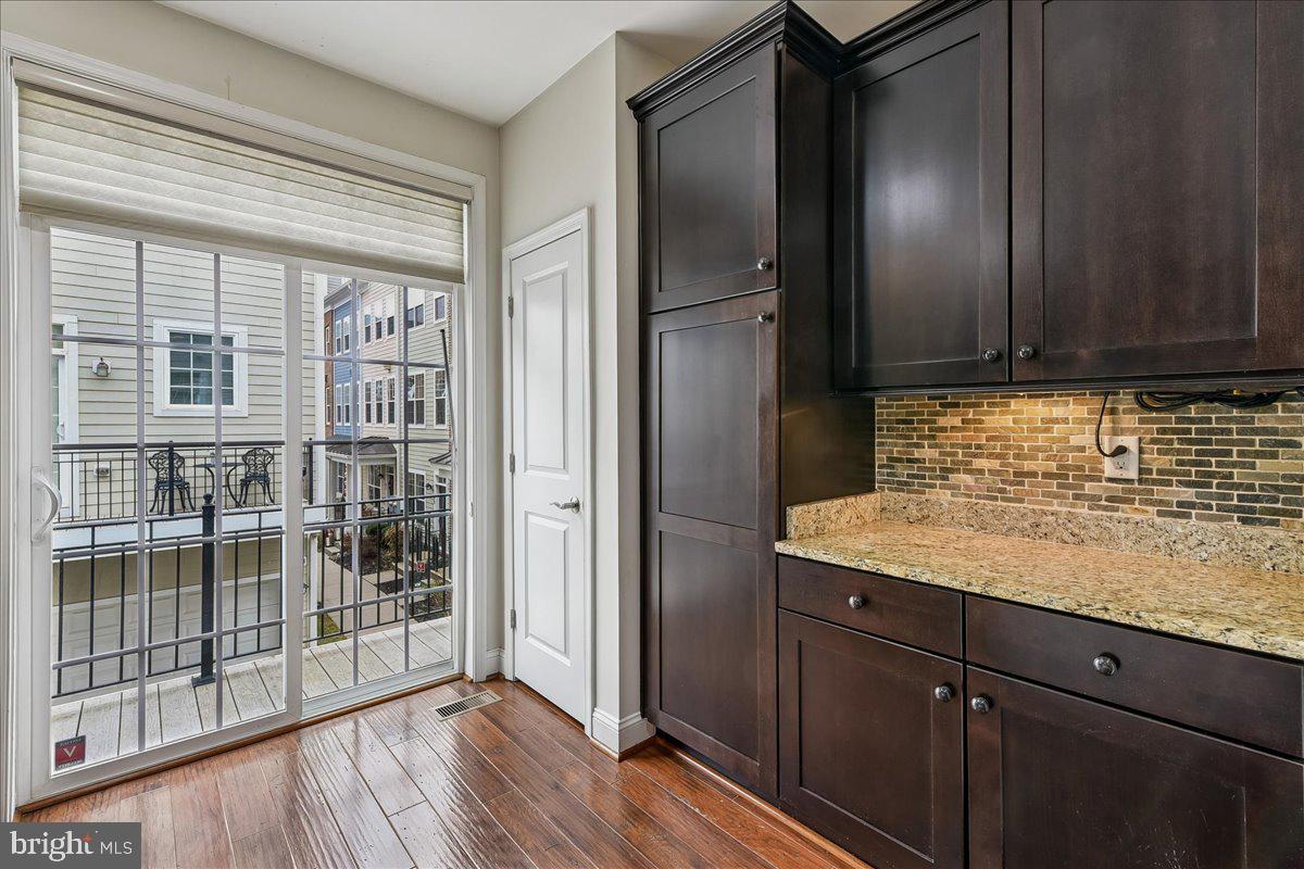 105 Meridian Lane Towson, MD 21286 - Photo 16 of 56 a kitchen with granite countertop wooden cabinets and a refrigerator