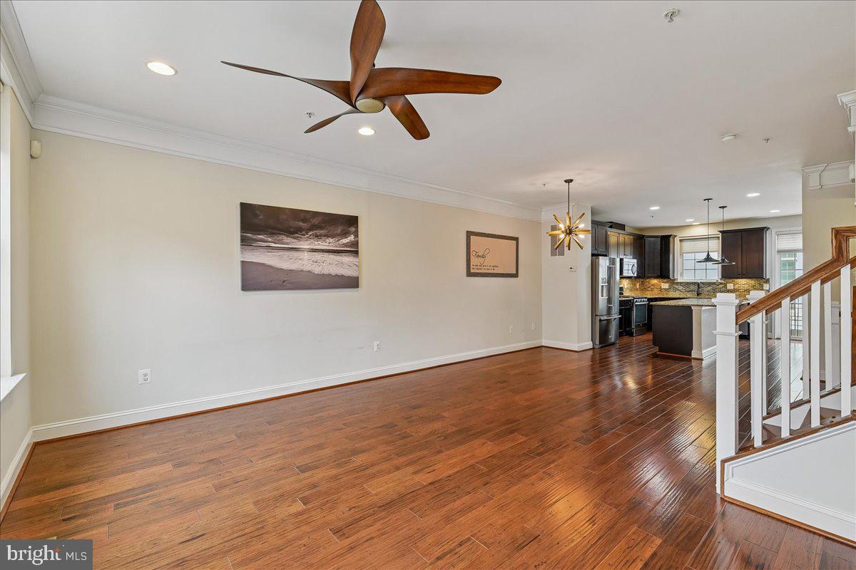 105 Meridian Lane Towson, MD 21286 - Photo 18 of 56 a view of a kitchen with wooden floor a ceiling fan and windows