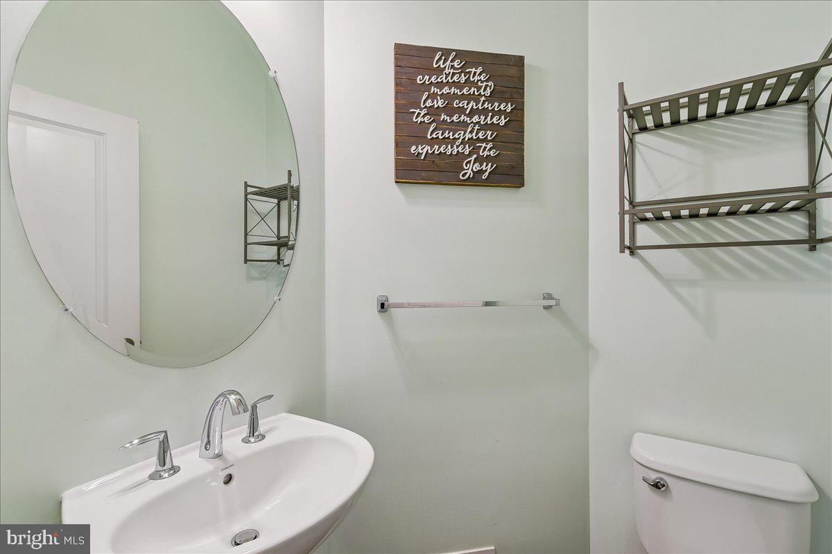 105 Meridian Lane Towson, MD 21286 - Photo 24 of 56 a bathroom with a sink a mirror a toilet and a mirror
