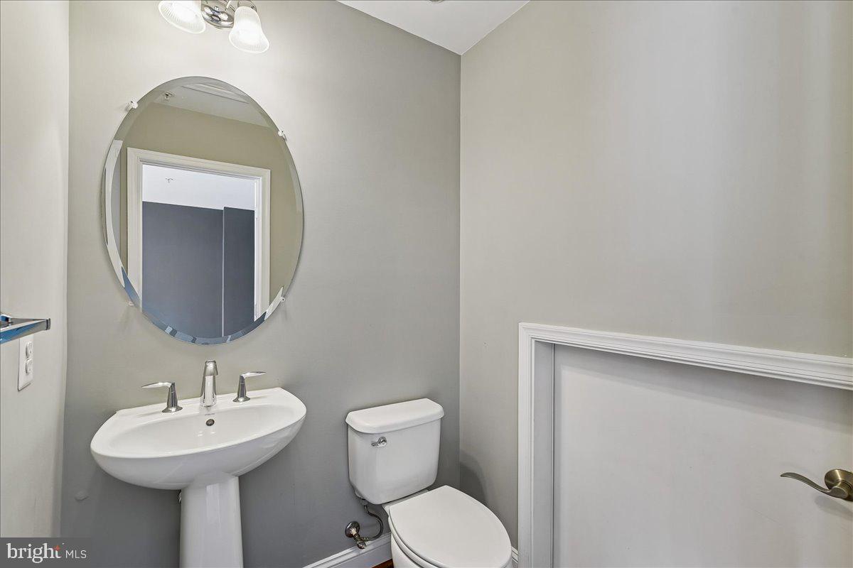 105 Meridian Lane Towson, MD 21286 - Photo 38 of 56 a bathroom with a toilet sink and mirror