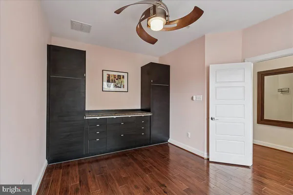 a view of entryway with wooden floor and stairs