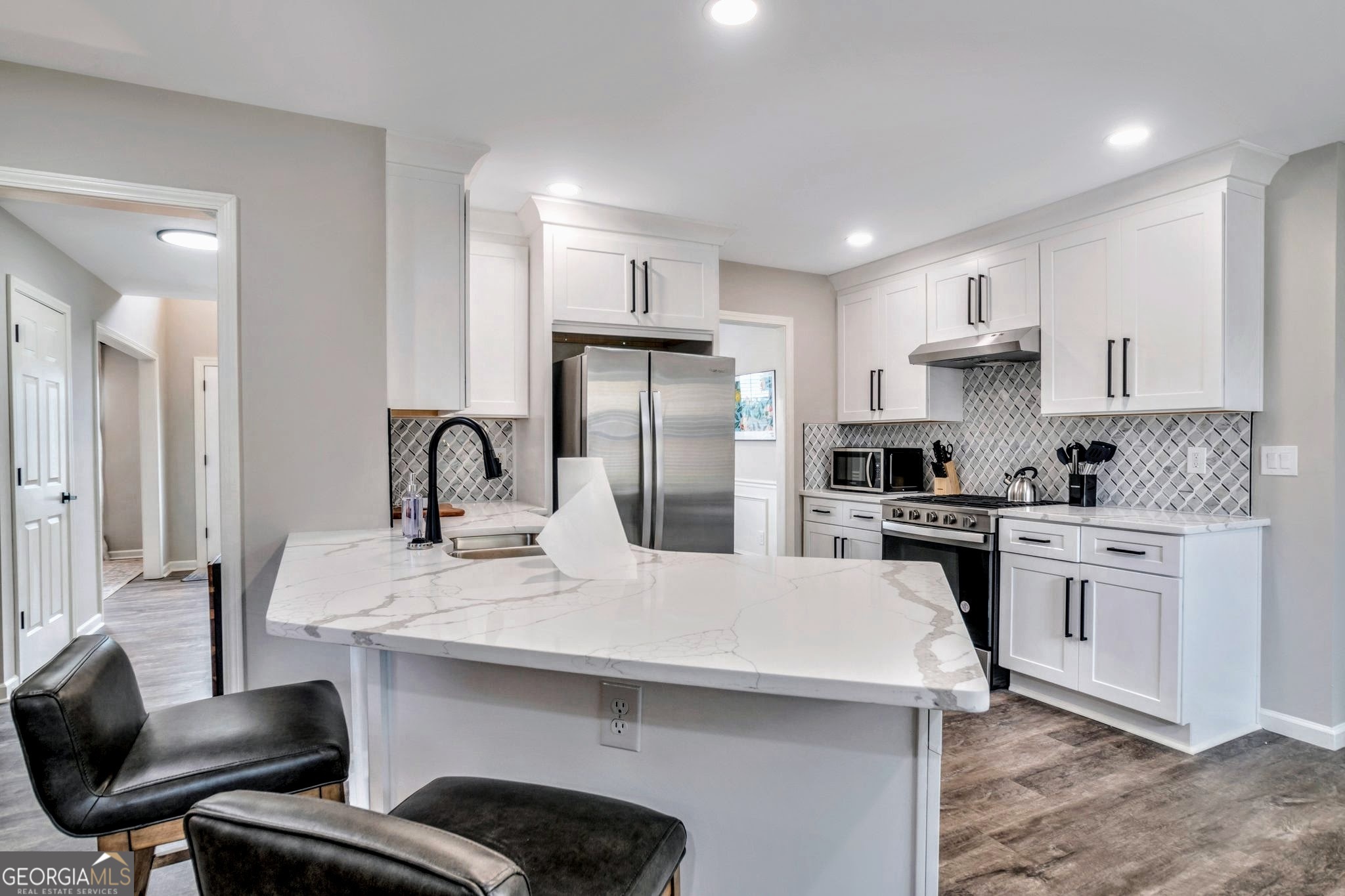 8008 Clearview Circle Riverdale, GA 30296 - Photo 11 of 31 a kitchen with a sink stainless steel appliances and white cabinets