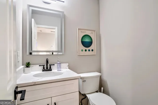 a bathroom with a toilet a sink and mirror