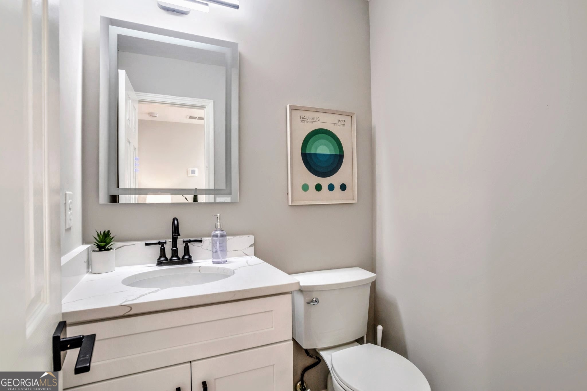 8008 Clearview Circle Riverdale, GA 30296 - Photo 14 of 31 a bathroom with a toilet a sink and mirror