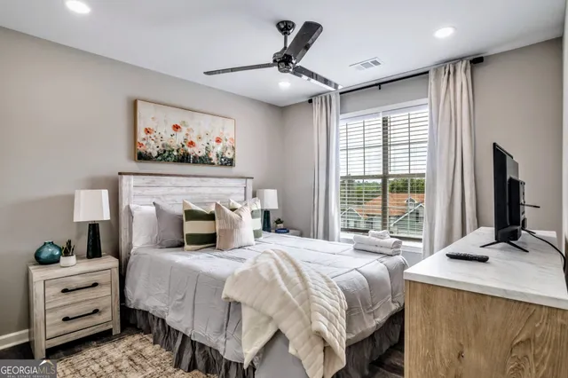 a bedroom with a bed and a flat screen tv