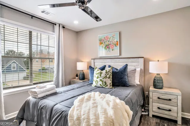 a bedroom with a bed and wooden floor