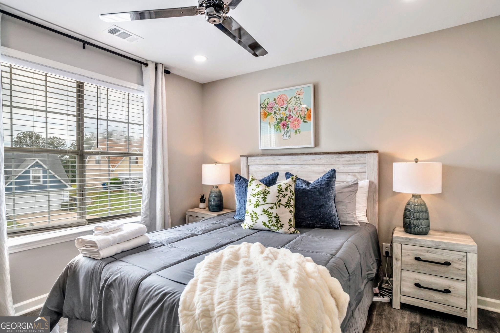 8008 Clearview Circle Riverdale, GA 30296 - Photo 17 of 31 a bedroom with a bed and wooden floor