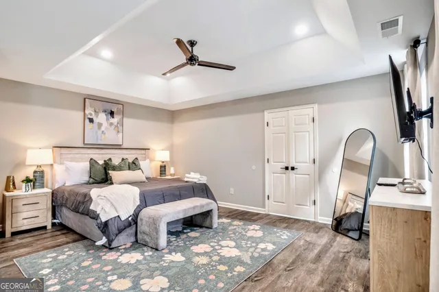 a bedroom with a bed a couch and a dresser