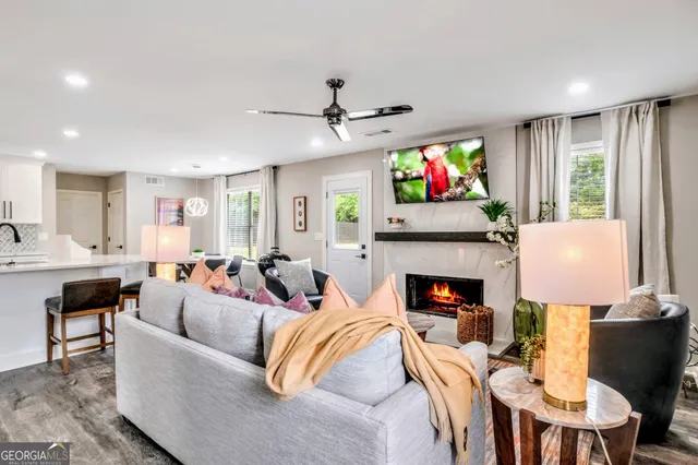 a living room with fireplace furniture and a flat screen tv