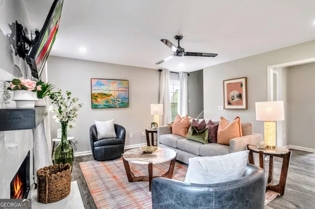 a living room with furniture and a chandelier