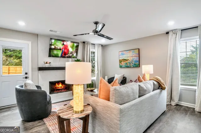 a living room with fireplace furniture and a flat screen tv
