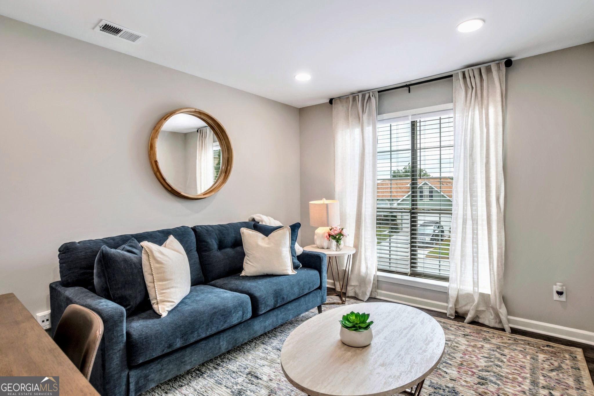 8008 Clearview Circle Riverdale, GA 30296 - Photo 6 of 31 a living room with furniture and a large window