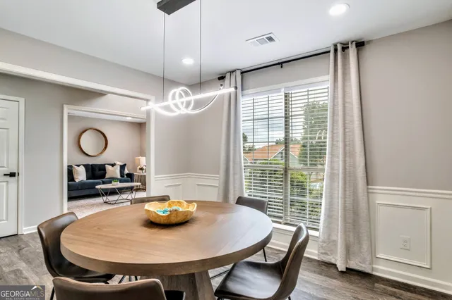 a view of a dining room with furniture window and wooden floor