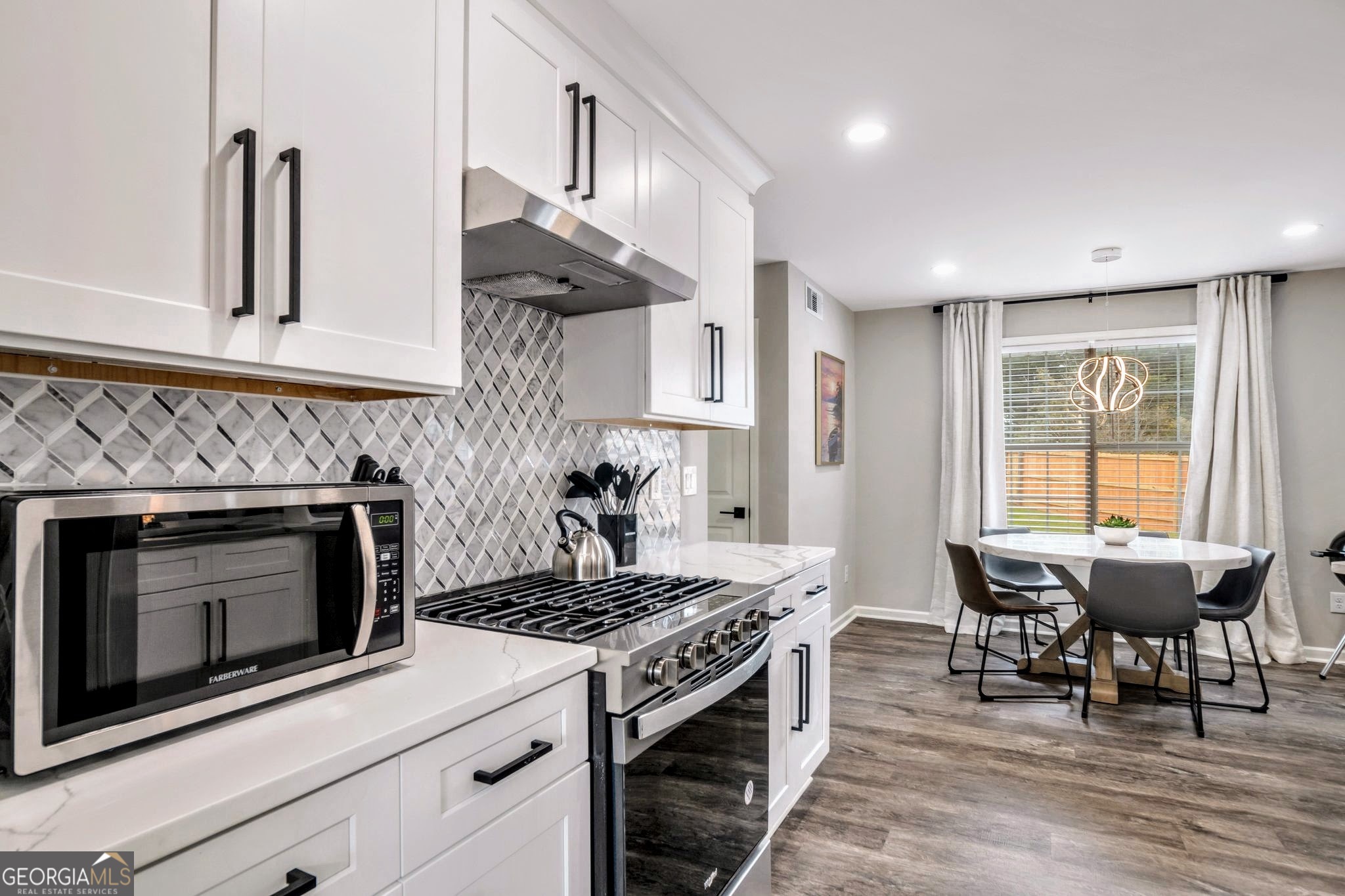 8008 Clearview Circle Riverdale, GA 30296 - Photo 9 of 31 a kitchen with a stove and chairs