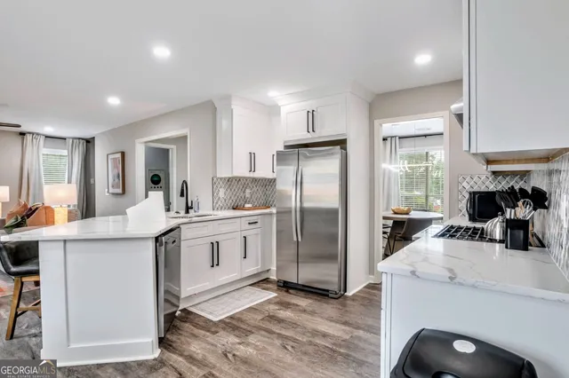 a kitchen with refrigerator and cabinets