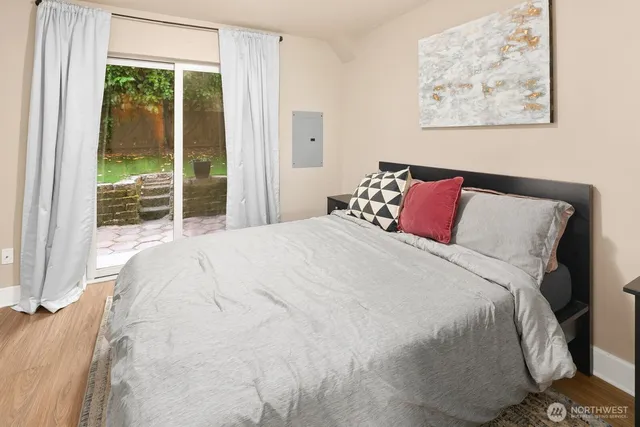 a large bed sitting in a bedroom next to a window