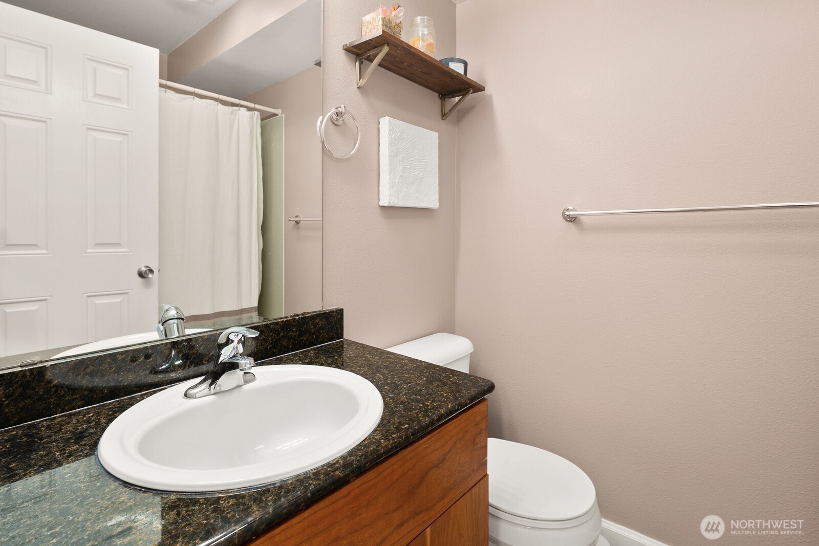3224 21st Avenue West, Unit B Seattle, WA 98199 - Photo 13 of 17 a bathroom with a granite countertop sink a mirror and a toilet