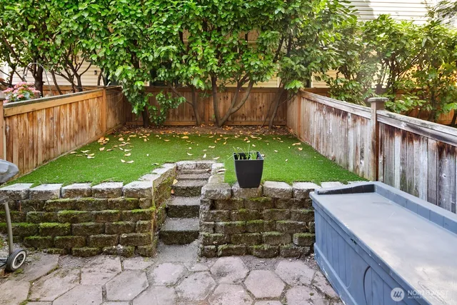 a view of a chairs and table in backyard
